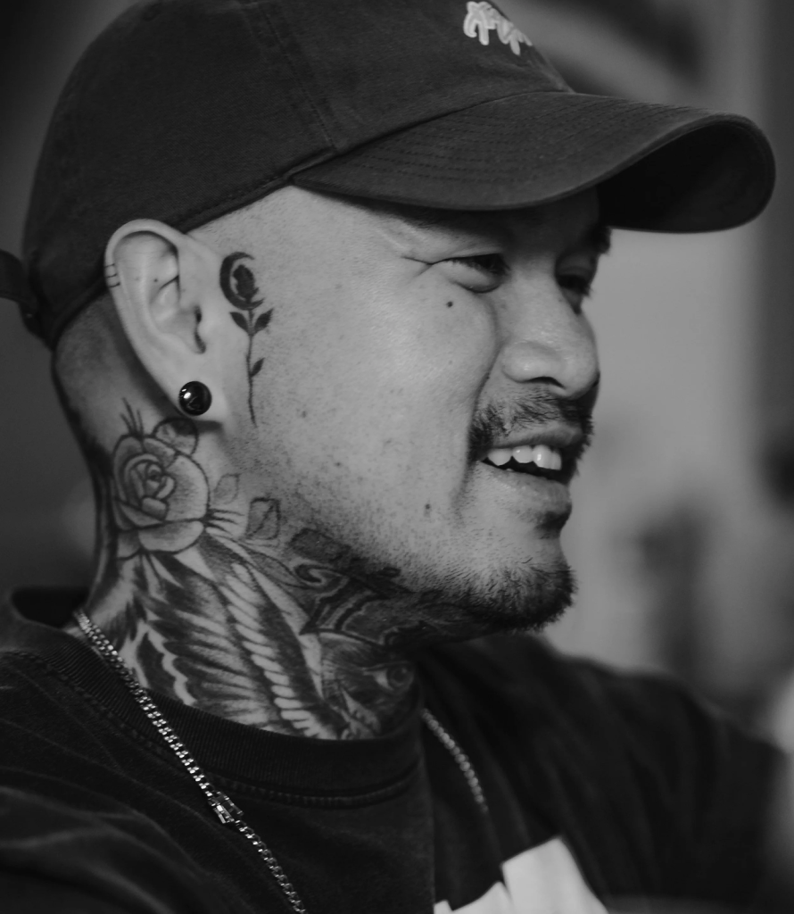 Tattoo artist and client reviewing a custom tattoo design during consultation