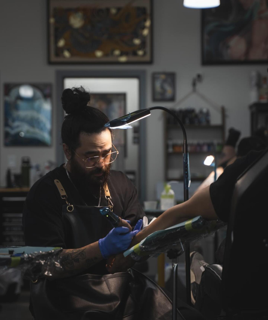 tattoo artist working on a client at The Hyve Studio New Westminster