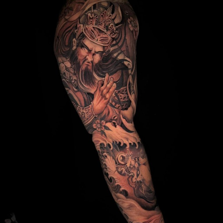 healed greyscale full-sleeve tattoo on man's arm